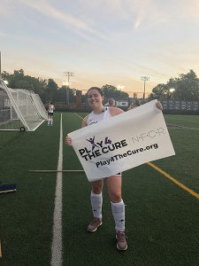 Field Hockey player with Play4theCure banner