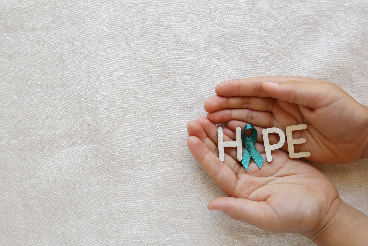 Hands holding hope with Cervical Cancer Awareness Month ribbon