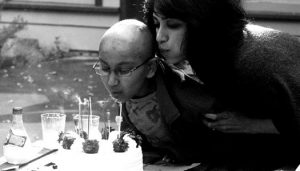 Purvi and Amaey Shah blow out candles on a birthday cake
