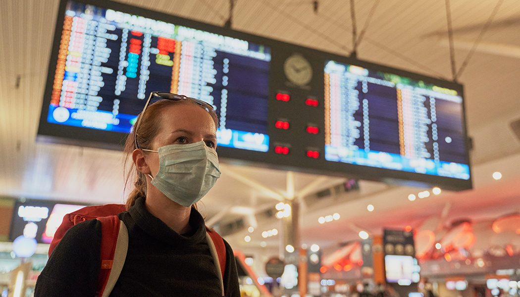 A NEw Guide to COVID-19 Air Travel: Traveler with a mask