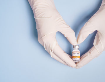 Doctor's hand in heart showing coronavirus vaccine