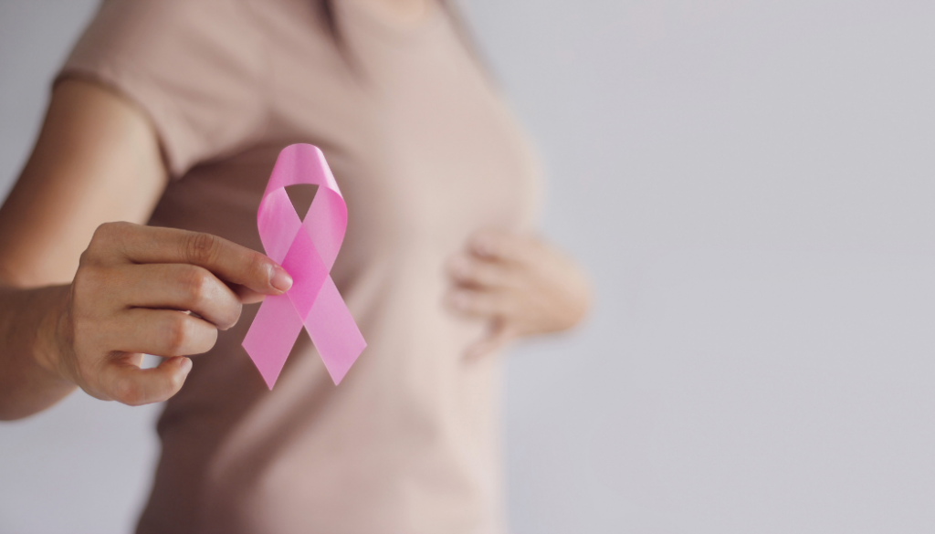 Young Woman Holds a pink breast cancer ribbon