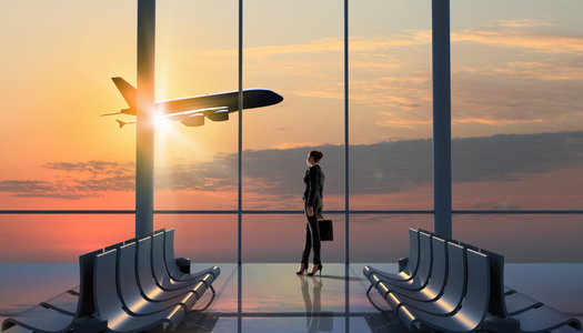 Business Woman Watches Plane Take Off from Airport