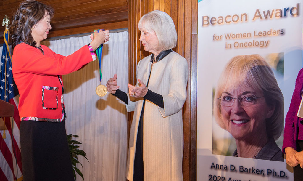 Sujuan Ba gives Beacon Award Medal to Anna D. Barker