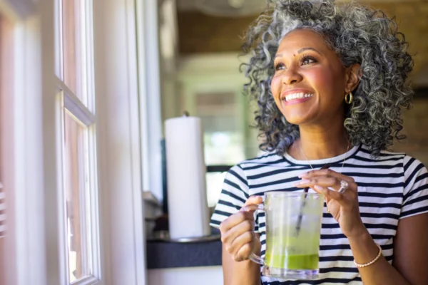 happy woman green smoothie